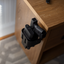 Reach 2S handgun safe mounted to the side of a nightstand with pistol secured, grip exposed for a quick draw